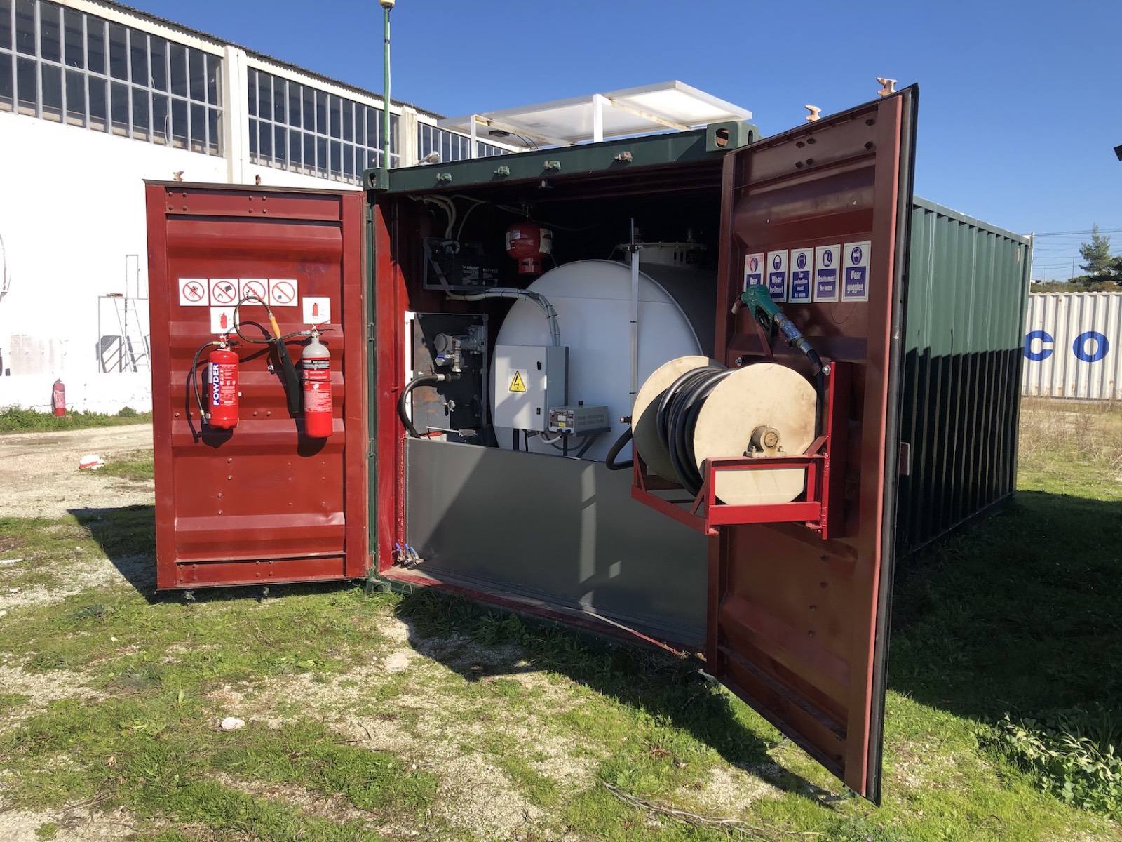 Autonomous container refuelling station with doors open