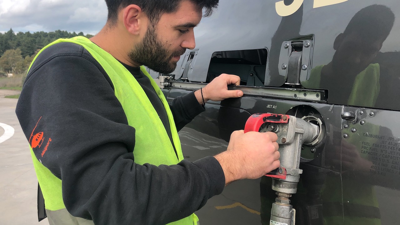 Ground crew refuelling a helicopter at Athens Heliport